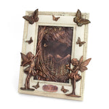 Decorative wall art with fairies, butterflies, and a mountain scene on a white background