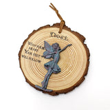 Decorative ornament with fairy figure and motivational quote on a wooden slice background