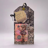 Decorative tag with fairy design and 'Faries Wear Boots' text on a textured background