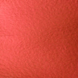 A close-up texture shot of a textured red material, likely paper or cardstock, filling the entire frame.