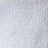 A close-up texture shot of a white, plush, and heavily textured fabric, likely a bouclé or sherpa material.