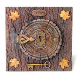 Decorative wooden plaque with keyhole, key, and 'BELIEVE' sign on a tree bark background.