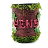 Decorative pot with 'HENS' text surrounded by greenery on a white background