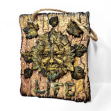 Decorative wall art with a face made of leaves and the word 'LIFE' on a white background