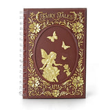 Notebook with gold fairy and floral design on a white background