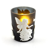 Black candle holder with a white fairy design on a white background