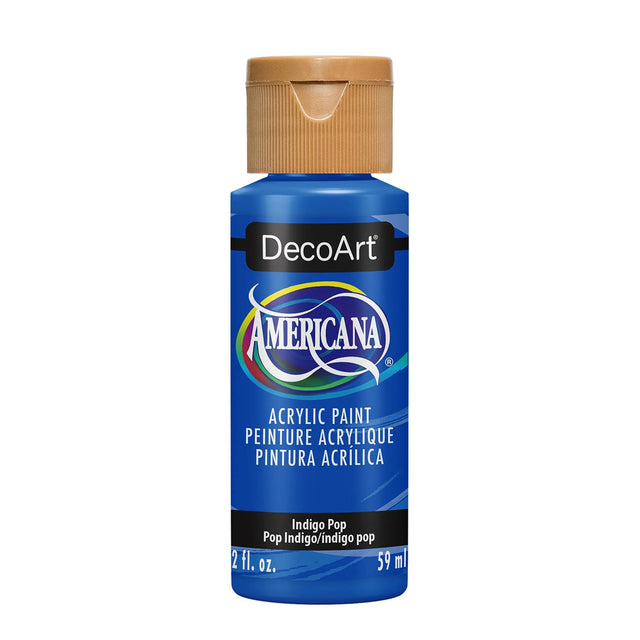 A bottle of DecoArt Americana acrylic paint in the color 'Indigo Pop', featuring a vibrant blue bottle, a tan ribbed cap, and a black label with the DecoArt logo.