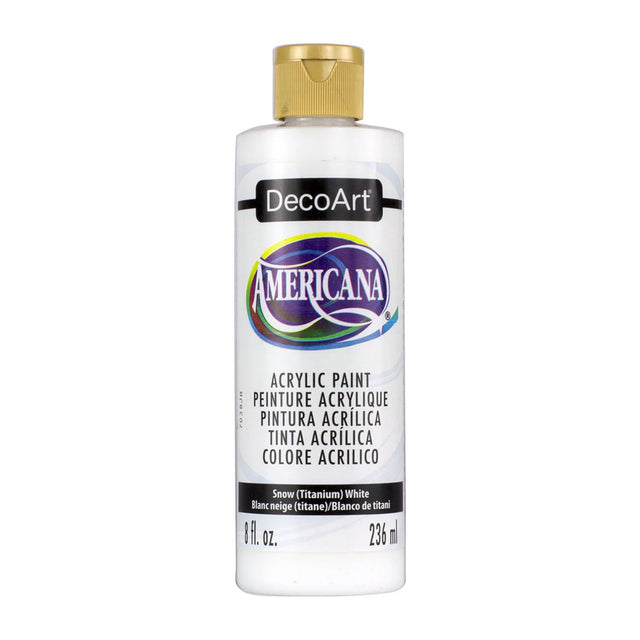 A bottle of DecoArt Americana acrylic paint in the color Snow (Titanium White), featuring a gold cap and a white label with purple and multicolor accents, set against a plain white background.