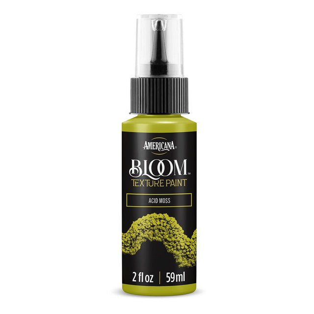 A bottle of Americana BLOOM Textured Paint in the shade Acid Moss, featuring a black label with a green moss texture graphic and a clear spray top.