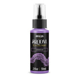 A bottle of Americana BLOOM Textured Paint in 'Lavender Ash' with a black label, purple cap and base, and a clear spray top, shown on a white background.