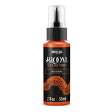 A bottle of Americana BLOOM Textured Paint in the color 'Molten Ochre', featuring a black label with orange paint splatter graphics and a clear spray cap.