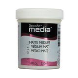 A white plastic jar of DecoArt Media Matte Medium with a white screw cap and a black, white, and pink label.