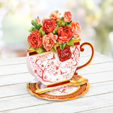 Decorative teacup with floral arrangement on a wooden surface
