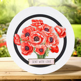 Round card with red flowers and 'Sent with Love' text on a wooden surface with a blurred natural background