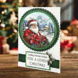 Christmas card with Santa Claus and festive text on a wooden surface with blurred Christmas decorations in the background.