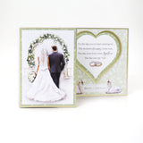 Wedding card with a couple under a floral arch and text.
