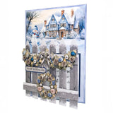 Christmas card with snowy village scene, snowman, and decorative elements.