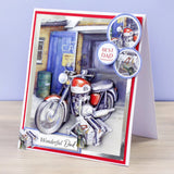 A handmade greeting card for Dad, featuring an illustration of a red and silver motorcycle parked in front of a garage. The card has red and white borders, circular embellishments, and the text 'BEST DAD' and 'Wonderful Dad'.