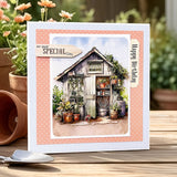 Garden-themed birthday card with a small shed and plants on a wooden surface.