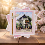 Birthday card with garden scene on a wooden surface with cherry blossoms