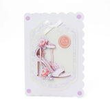 Greeting card with high-heeled shoes and flowers on a white background