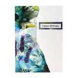 A vertical greeting card with a watercolor floral design in shades of blue, purple, green, and white on the left side, and a plain white right side featuring a small rectangular label that reads 'Happy Birthday'.