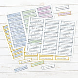 A set of printed sympathy and greeting sticker sheets arranged on a whitewashed wood background. The stickers are mostly light blue, gray, and lavender with gold borders and text such as 'Thinking of You,' 'Get Well Soon,' 'Love and Hang,' 'Just to Say,' and 'In my thoughts.