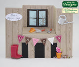 Card with garden-themed elements including a window, tools, and a banner reading 'Garden'.