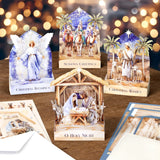Collection of Christmas cards featuring nativity scenes and angel figures on a wooden surface with blurred lights in the background.