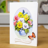 Greeting card with colorful flowers and butterflies on a wooden surface