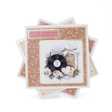 Stack of anniversary cards with floral design and vinyl record on a white background