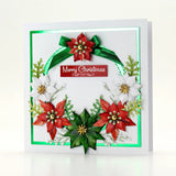 A square white greeting card with a 3D layered Christmas wreath design, featuring red poinsettias, white flowers, green leaves, a green ribbon bow, and a central red banner that reads 'Merry Christmas'.