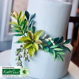 White cake with green leaf decoration on a white background