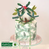 Decorative cake with greenery and a bow, featuring Lorna Sansom Katy Sue Flower Emporium branding.