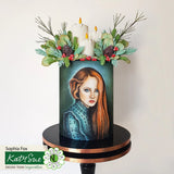 Decorative candle with floral arrangement and portrait on a white background