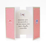 Greeting card with pink interior and decorative bows on a white background
