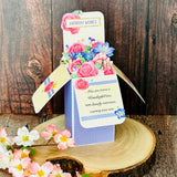 Decorative birthday card with floral design on a wooden surface