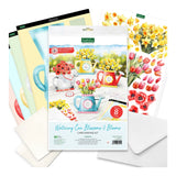 Kettle Sips 'Wintering Can Blossoms & Blooms' card making kit, showing the main package with floral watercolor illustrations, surrounded by included craft sheets and white envelopes on a clean white background.