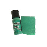 Green bottle of distress paint with a swatch on a white background