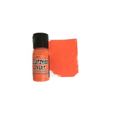 Bottle of distress paint with a swatch of orange color on a white background