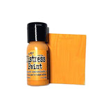 Bottle of Ranger Distress Paint with a swatch of orange color on a white background